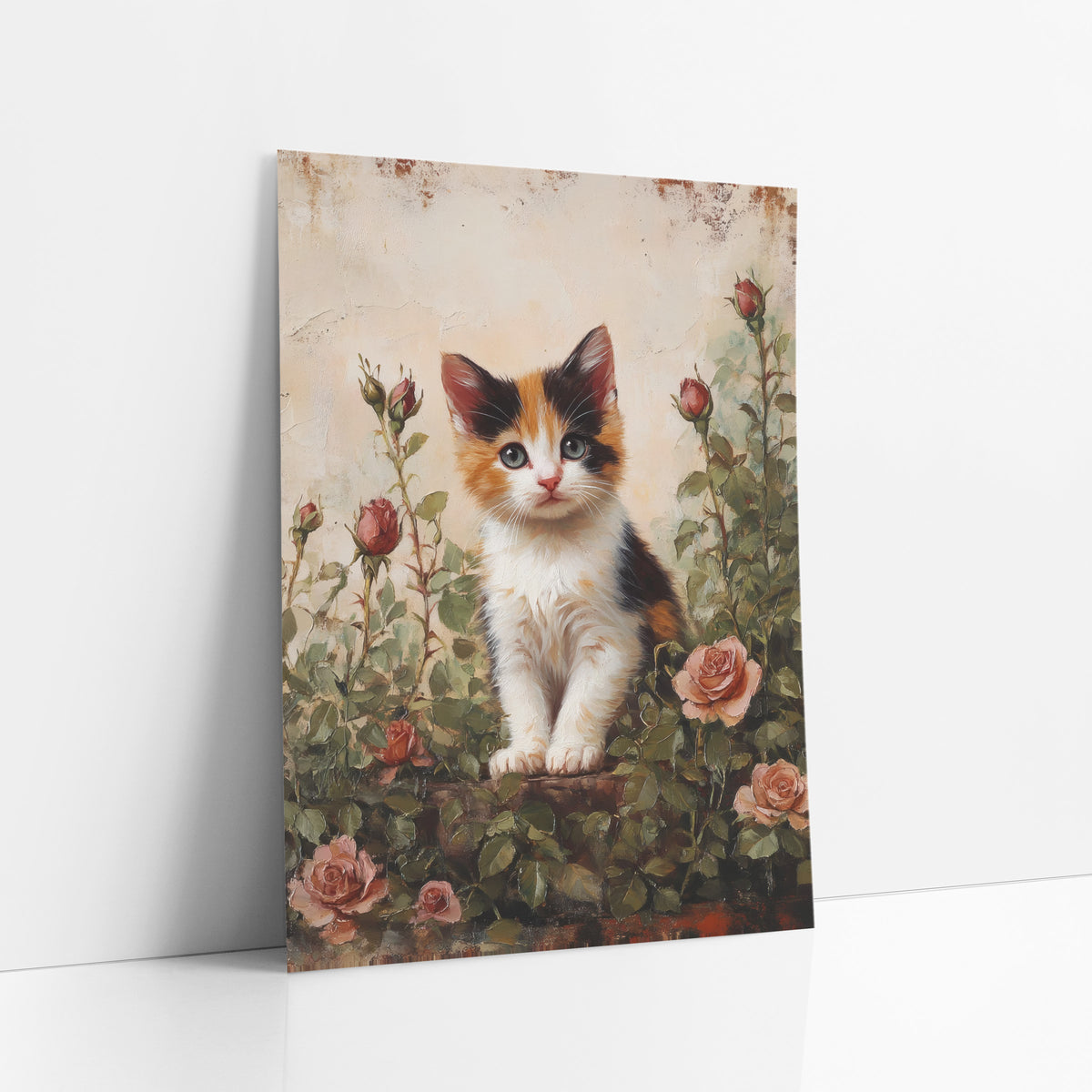 Calico Kitten Tall Rosebuds Vintage art print leaning against a white wall – calico kitten sitting among pink roses and red
