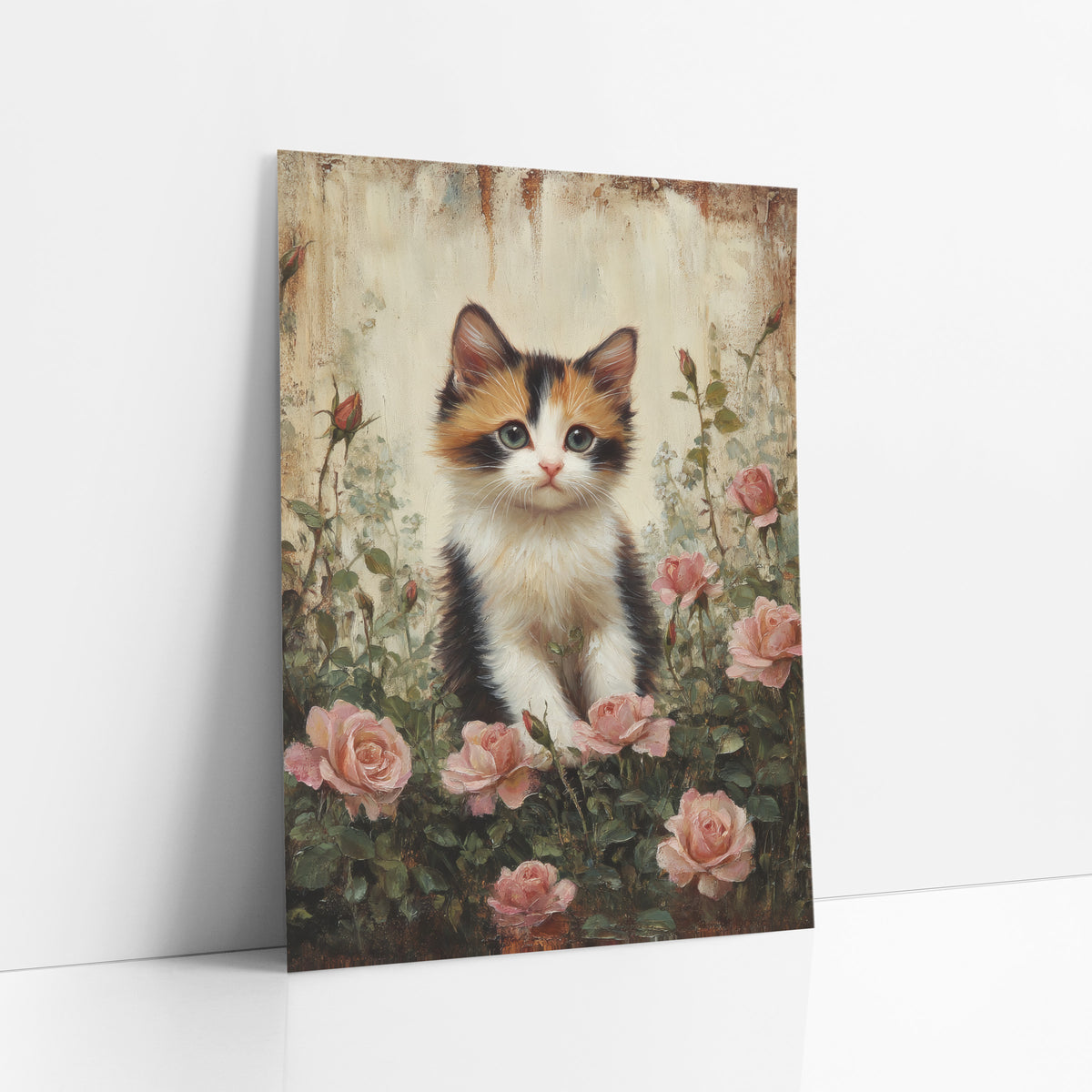 Fluffy Calico Blush Roses Painterly art print leaning against a white wall – calico kitten with green eyes sitting among pink