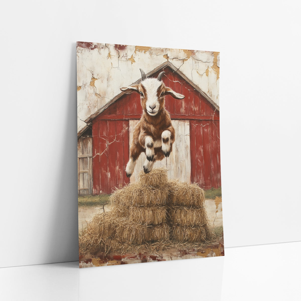Front-Facing Horned Goat Haystack Rustic art print leaning against a white wall – baby goat leaping over stacked hay bales