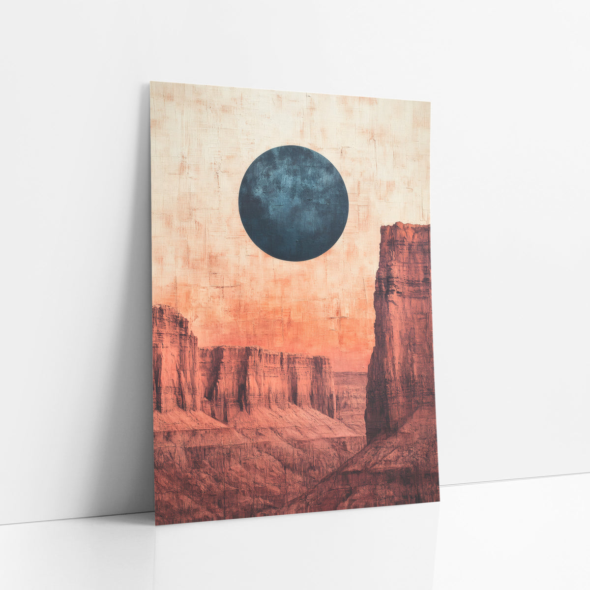 Blue Moon Red Mesa Desert art print leaning against a white wall – large dark blue moon above layered red rock mesas