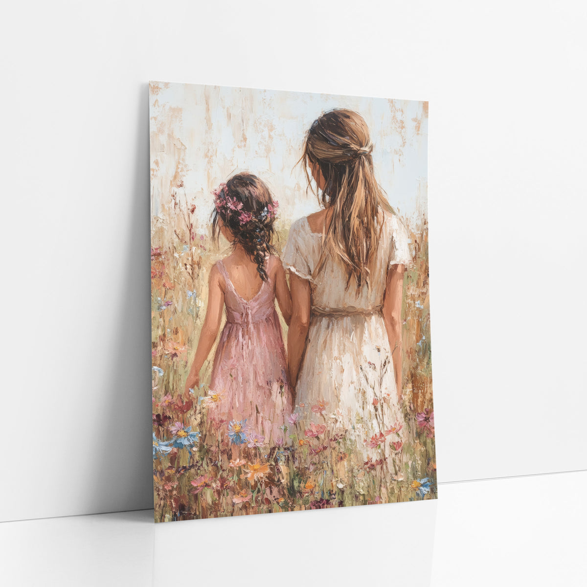 Wildflower Walk Boho Cottage art print leaning against a white wall – woman in cream dress and girl in pink dress with flower