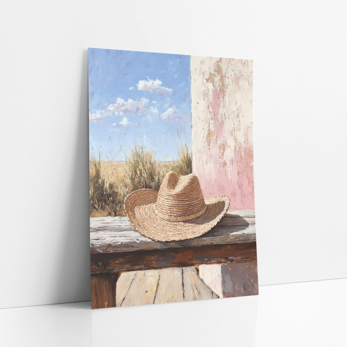 Straw Hat Rustic Prairie Boho art print leaning against a white wall – woven straw hat on a weathered wooden bench