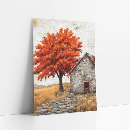 Fiery Maple Stone Cottage Rustic art print leaning against a white wall – orange-red maple tree beside a gray stone cottage