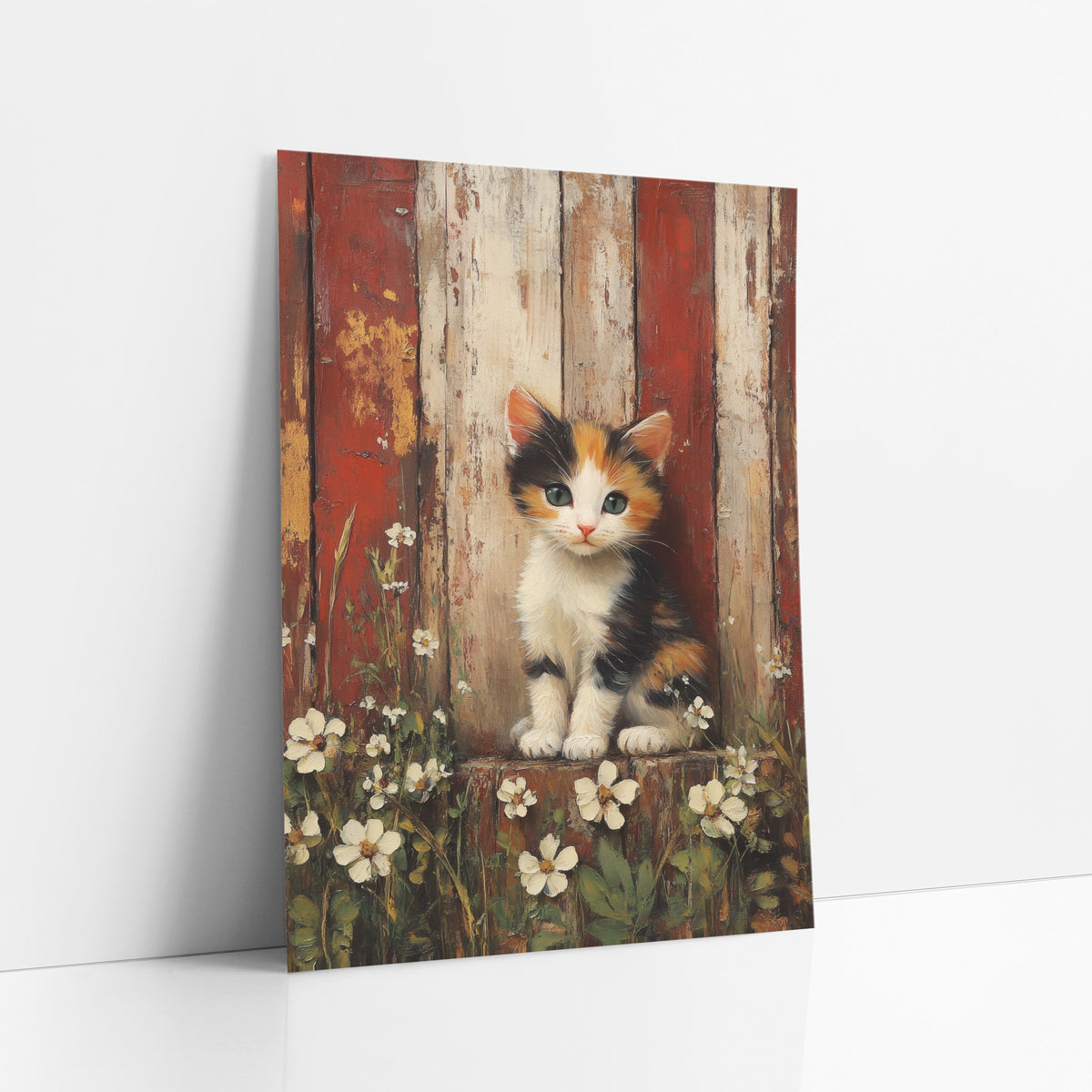 Calico Kitten Red Barn Farmhouse art print leaning against a white wall – calico kitten with green eyes sitting among white