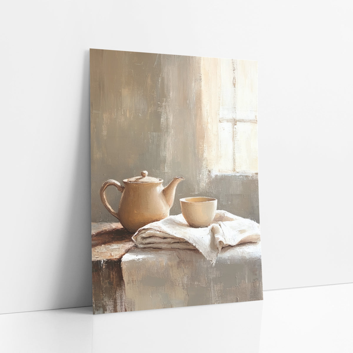 Window Light Teapot Cloth Still art print leaning against a white wall – cream teapot and small cup on folded linen cloth
