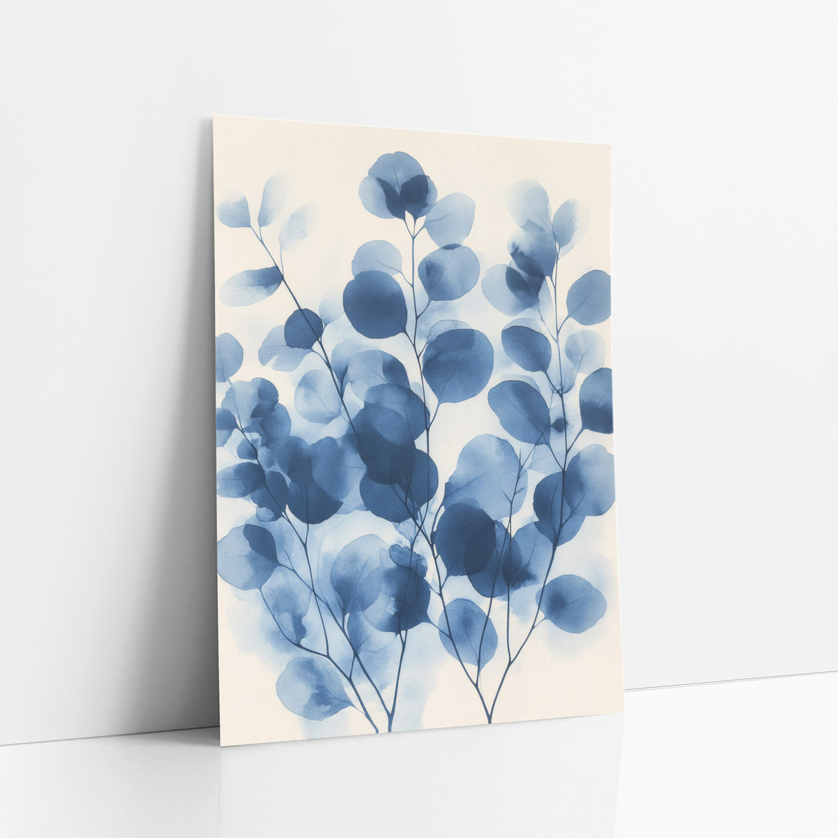Layered Overlapping Indigo Eucalyptus Botanical art print leaning against a white wall – round eucalyptus leaves on thin