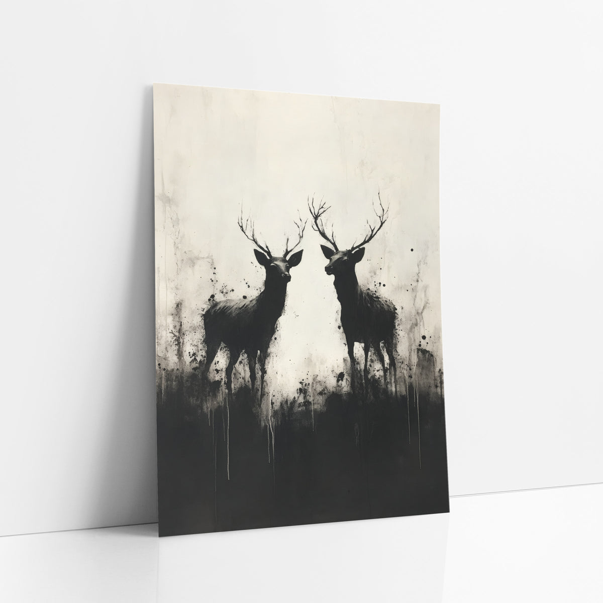 Twin Stag Silhouettes Ink Style art print leaning against a white wall – two black antlered deer in silhouette facing each