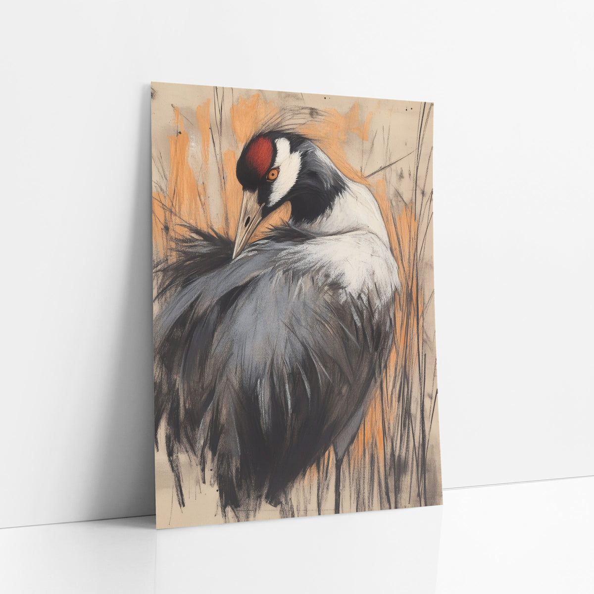 Preening Crane Charcoal Sketch Bird art print leaning against a white wall – crane with bowed head and red crown in gray