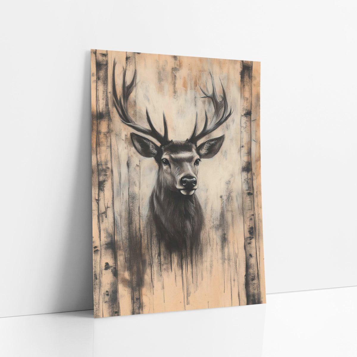 Stag Between Birch Trunks Charcoal art print leaning against a white wall – charcoal-look stag portrait with wide antlers