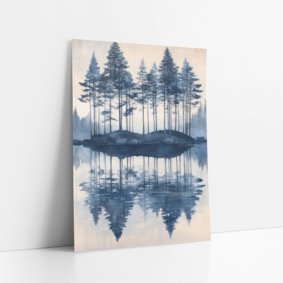 Indigo Evergreen Island Reflection Landscape art print leaning against a white wall – tall evergreens on a small rocky island