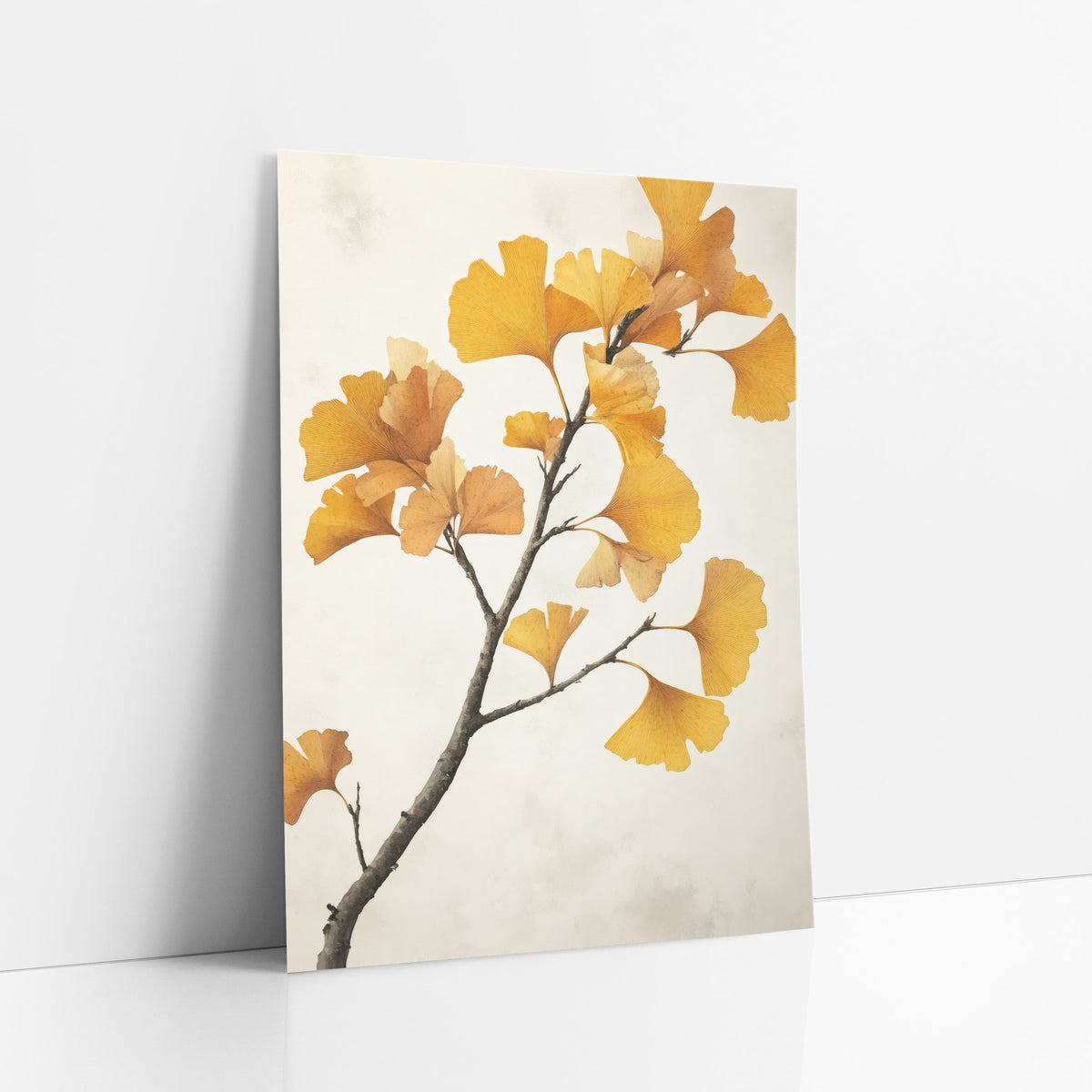 Ginkgo Pale Mist Branch art print leaning against a white wall – ginkgo branch with golden yellow fan-shaped leaves and fine