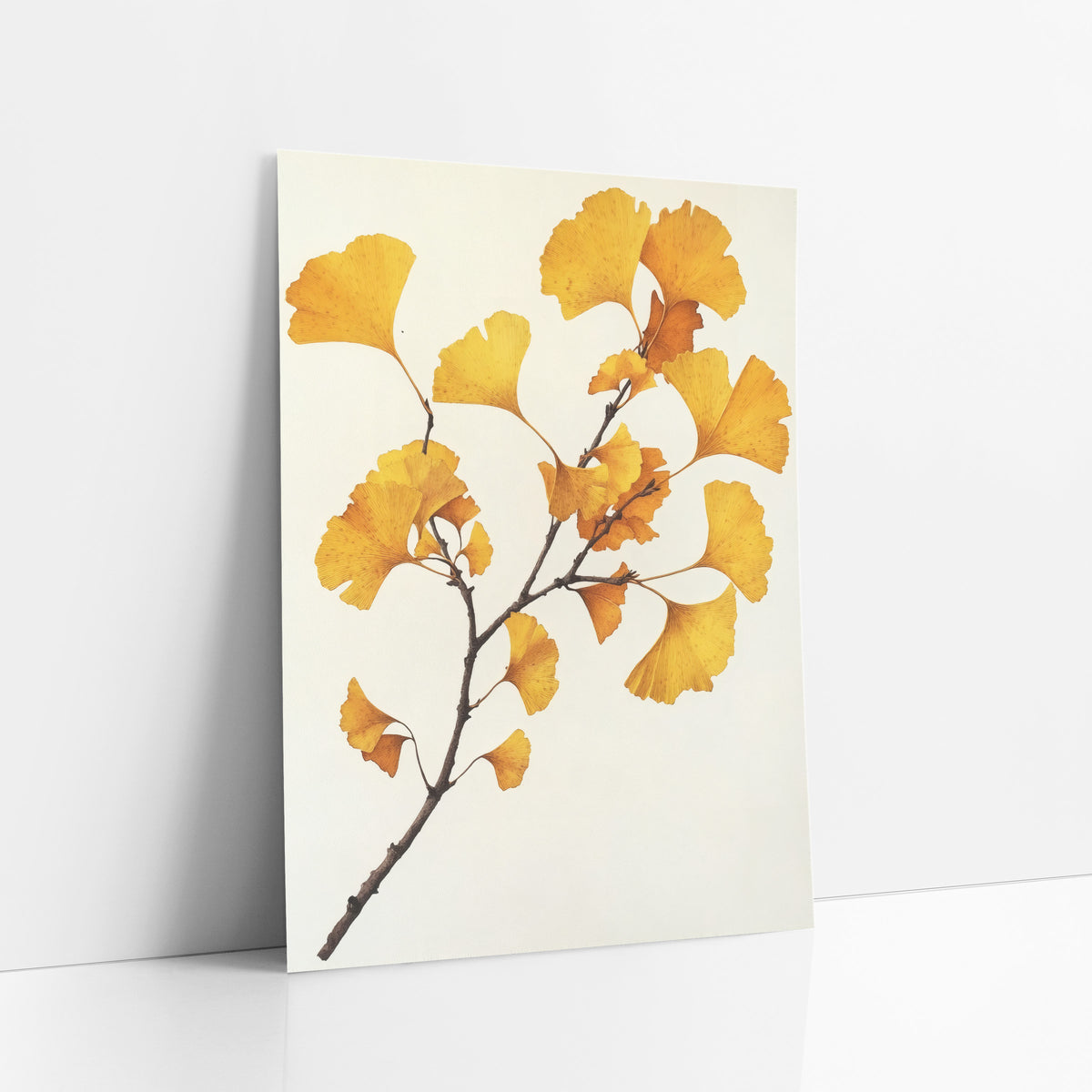 Ginkgo Clean Ivory Spray art print leaning against a white wall – ginkgo branch with golden yellow and amber fan-shaped