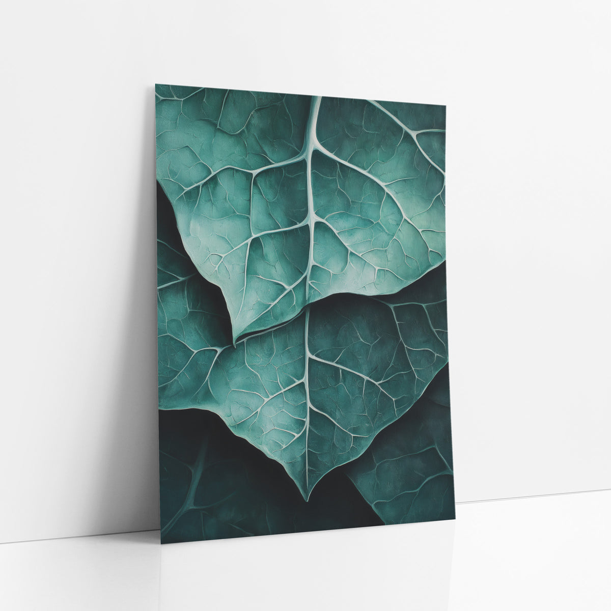 Overlapping Teal Leaves Macro art print leaning against a white wall – close view of overlapping teal alocasia leaves
