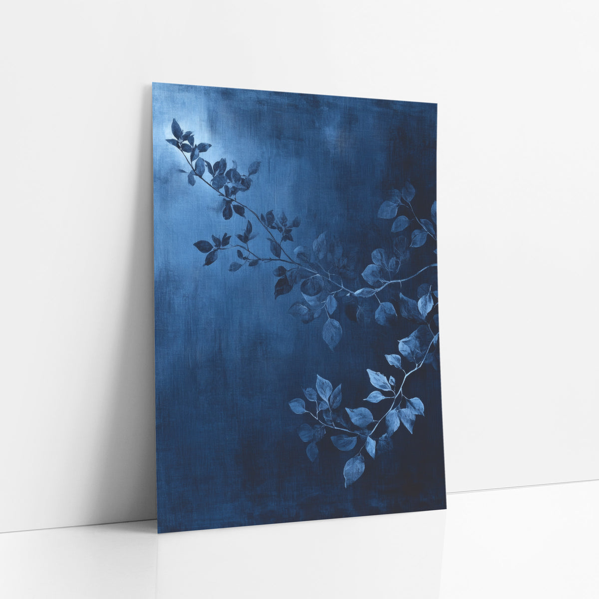 Moonlit Indigo Boughs Painted art print leaning against a white wall – slender leafy branches in steel blue across a deep