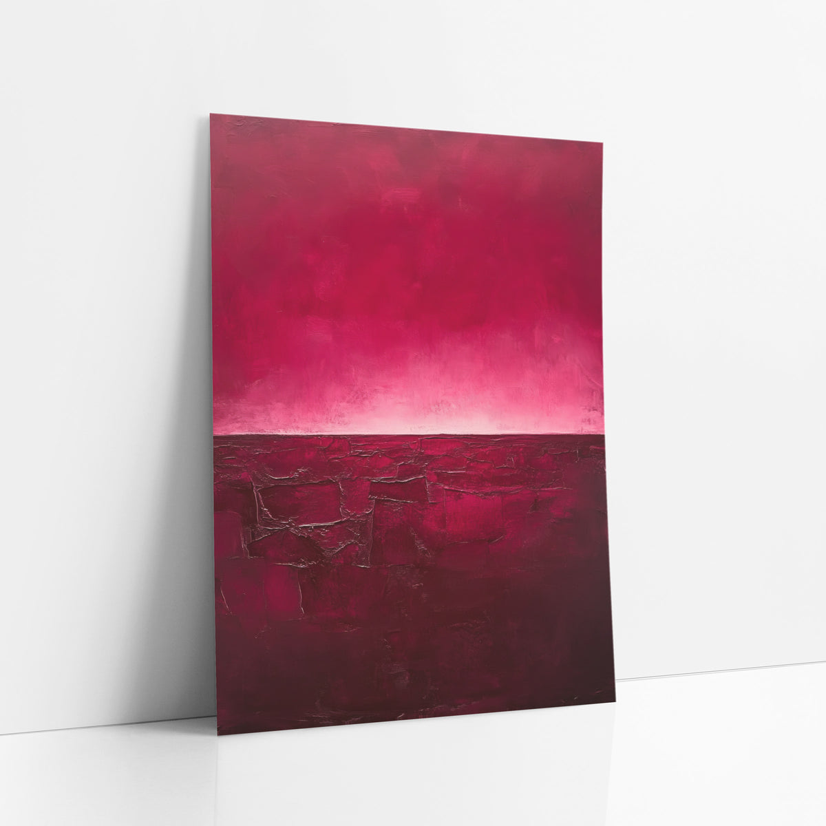Crimson Cracked Earth Abstract art print leaning against a white wall – abstract landscape with a magenta sky glowing pale