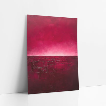 Crimson Cracked Earth Abstract art print leaning against a white wall – abstract landscape with a magenta sky glowing pale