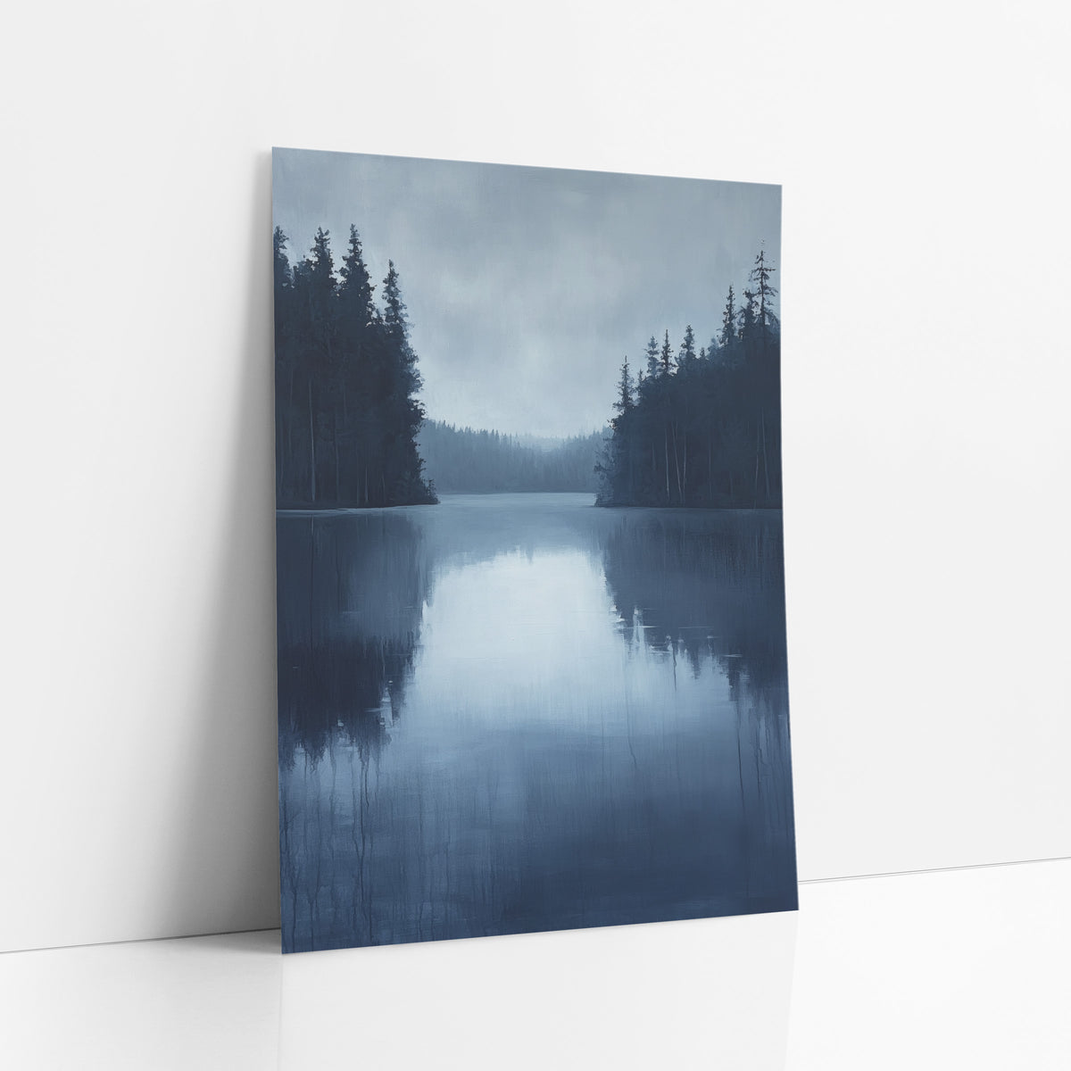Misty Evergreen Lake Landscape art print leaning against a white wall – still blue lake between dark evergreen shores