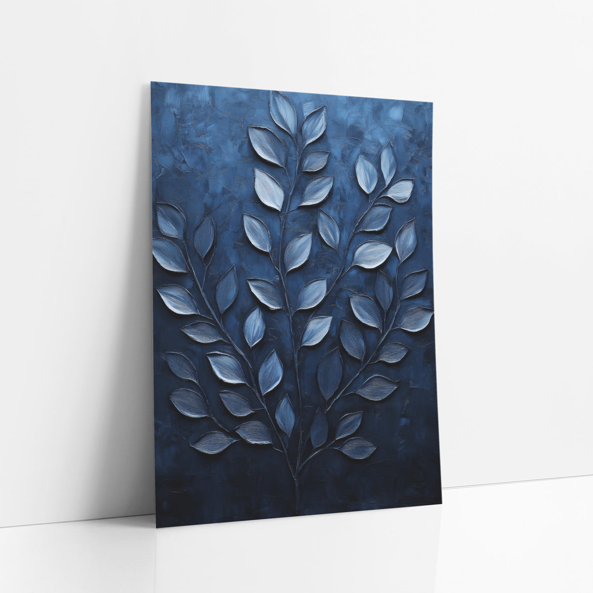 Navy Leafy Branch Botanical Luxe art print leaning against a white wall – silvery-blue leaves on three slender branches