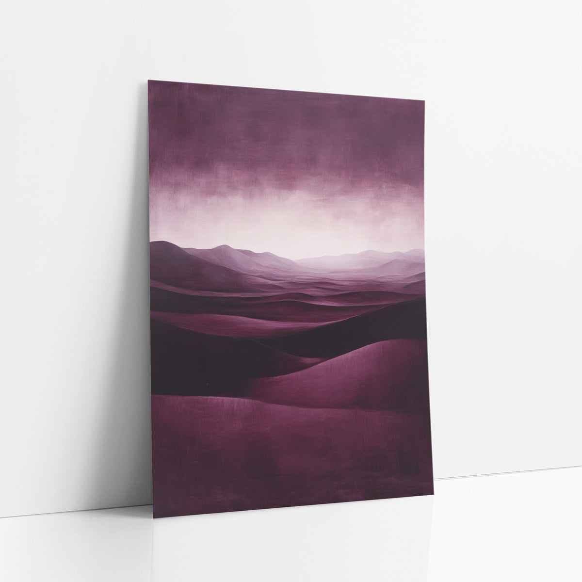 Burgundy Dune Glow Luxe Landscape art print leaning against a white wall – deep burgundy desert dunes rolling toward a pale