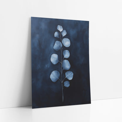 Navy Glow Eucalyptus Stem Moody art print leaning against a white wall – single eucalyptus stem with round pale blue leaves