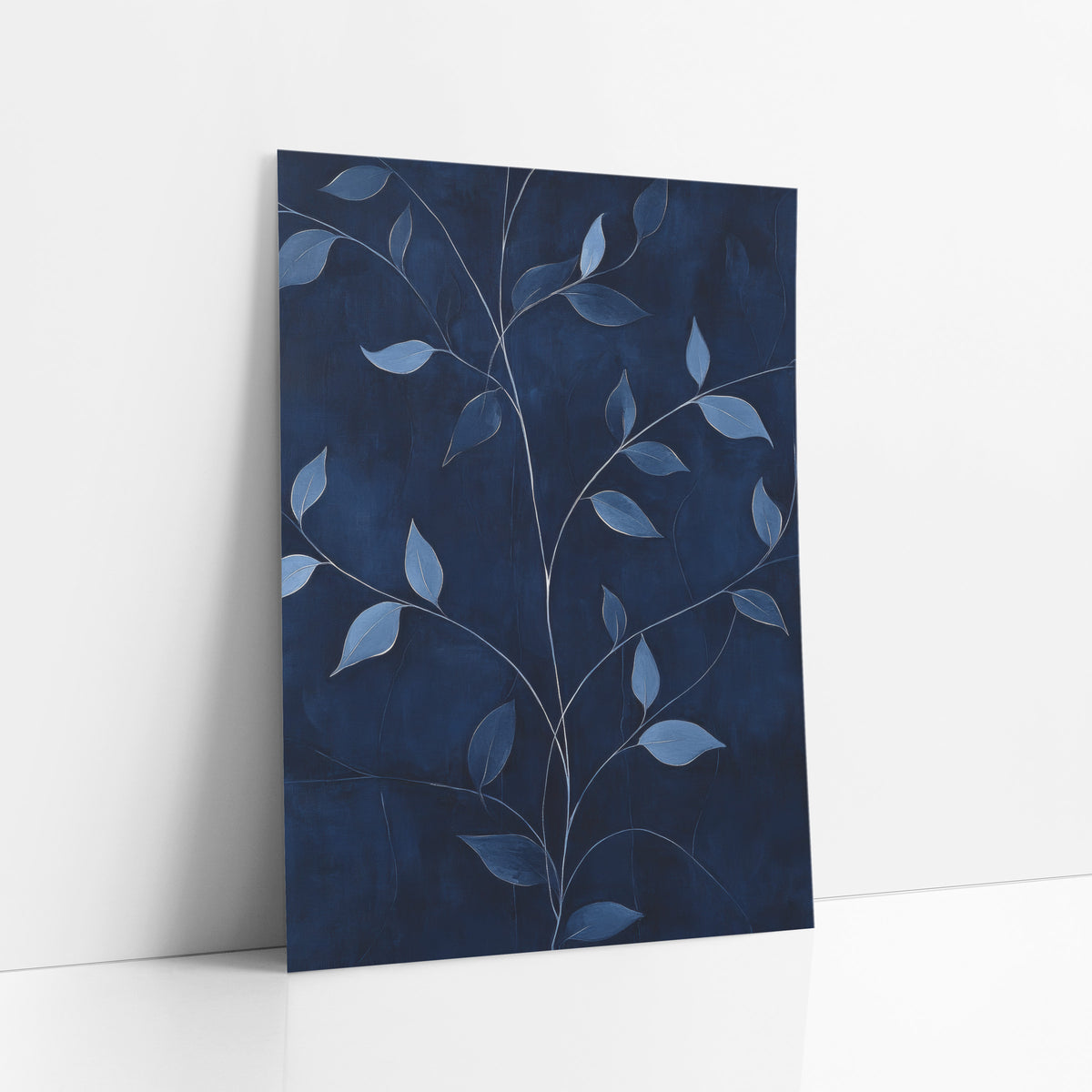 Navy Blue Vine Leaf Botanical art print leaning against a white wall – branching vine stems with dusty blue leaves and pale