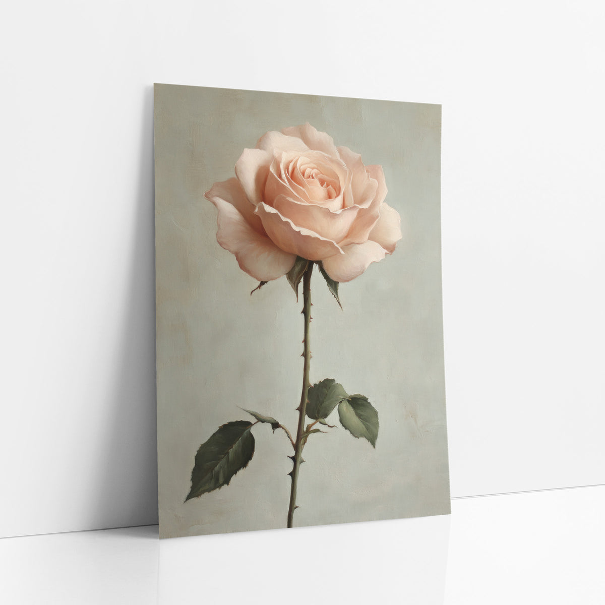 Blush Garden Rose Romantic Botanical art print leaning against a white wall – single blush pink garden rose on a long thorny