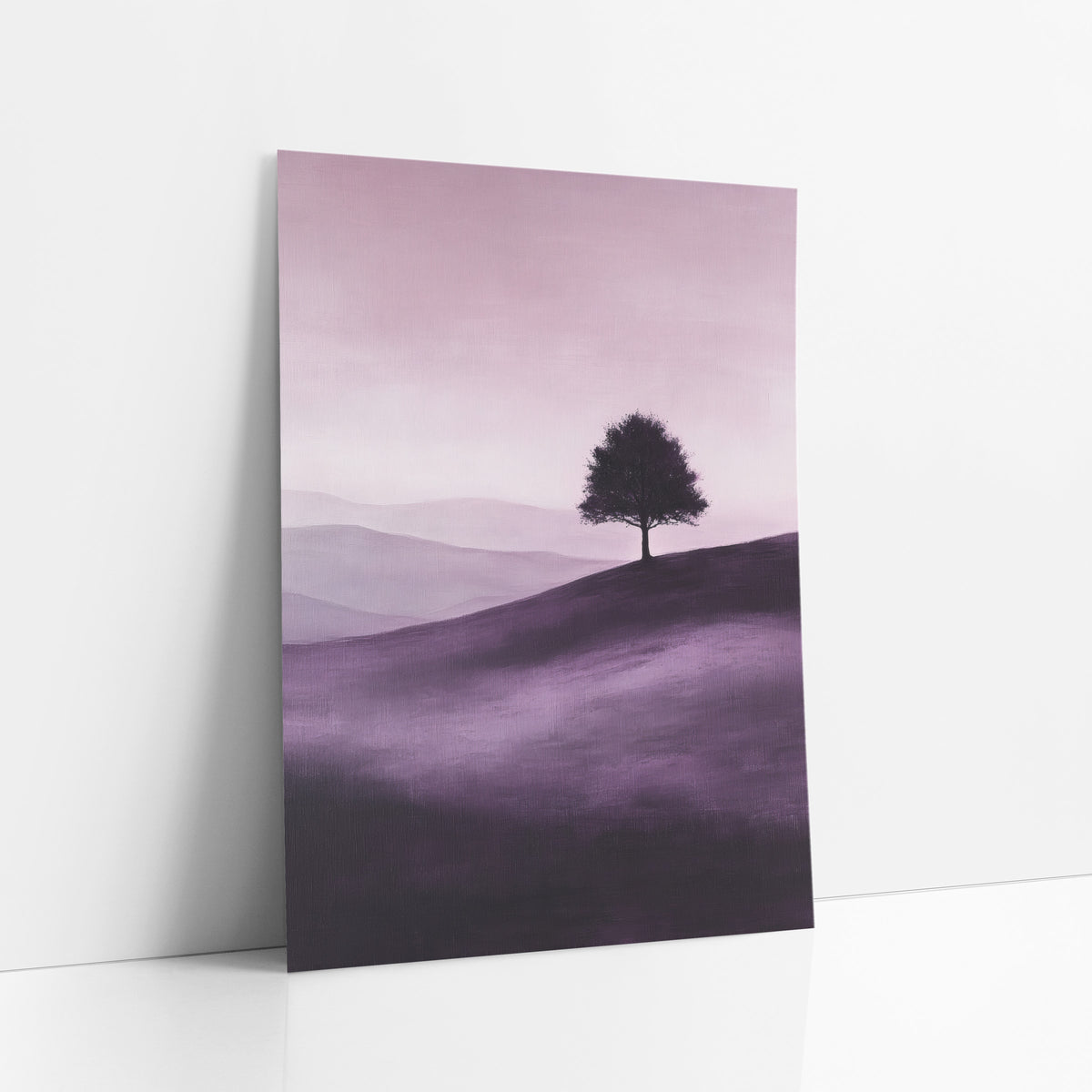 Violet Rolling Hills Silhouette Tree art print leaning against a white wall – lone round tree silhouetted on a rolling hill