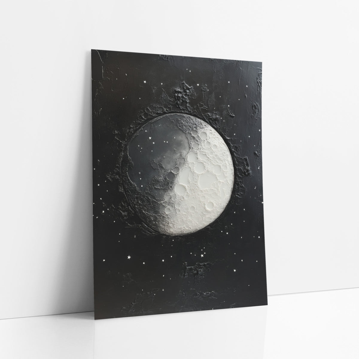 Cratered Moon Starfield Celestial art print leaning against a white wall – half-lit gray and white cratered moon surrounded