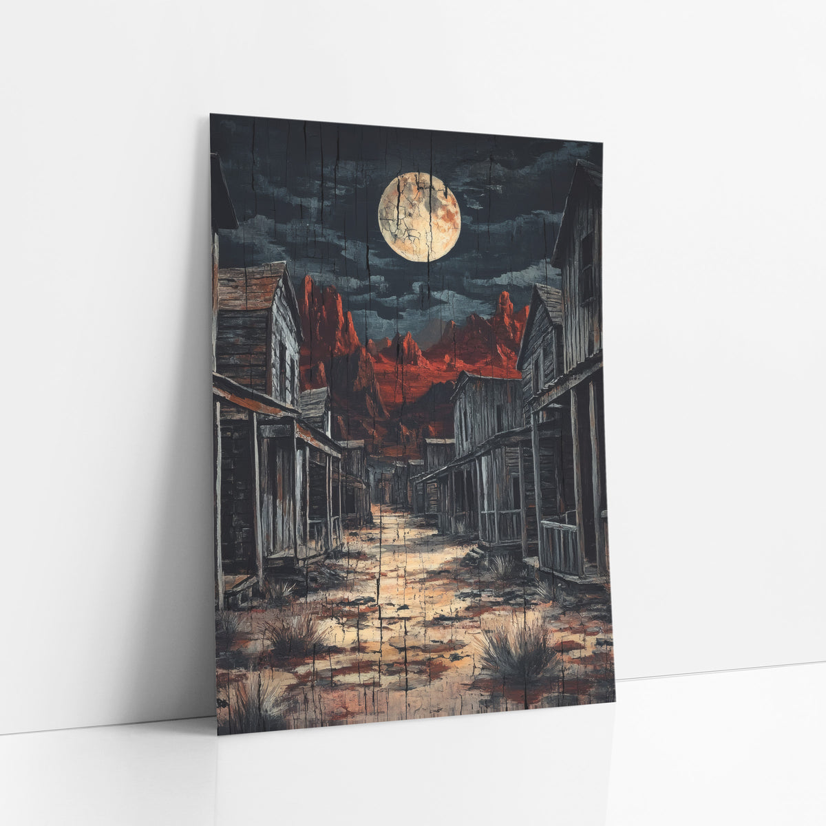 Moonlit Ghost Town Western art print leaning against a white wall – full moon over an empty western street of weathered