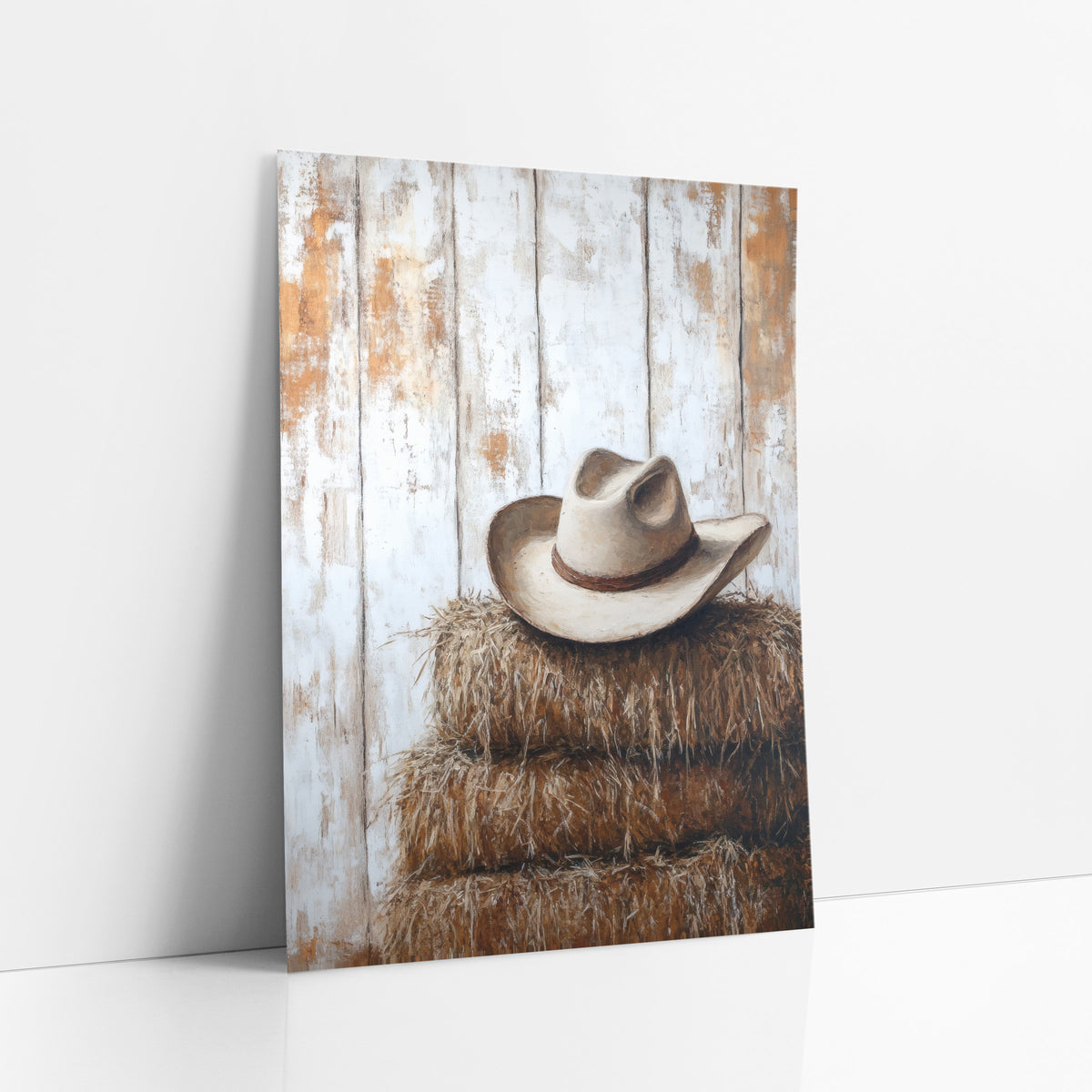 Cream Cowboy Hat Haybales Western art print leaning against a white wall – cream cowboy hat with brown band on stacked hay