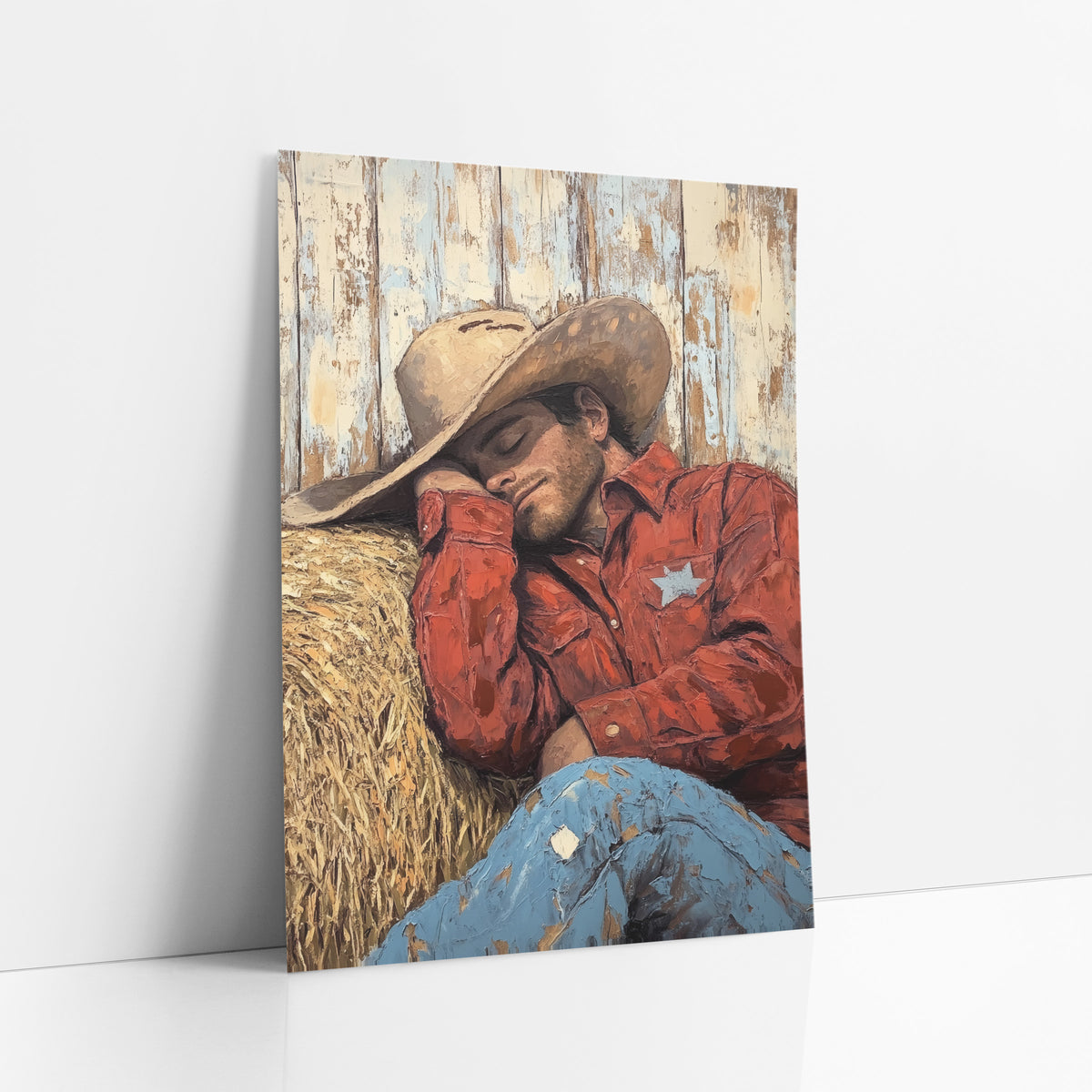 Sleeping Cowboy Hay Bale Western art print leaning against a white wall – cowboy in tan hat and red shirt asleep