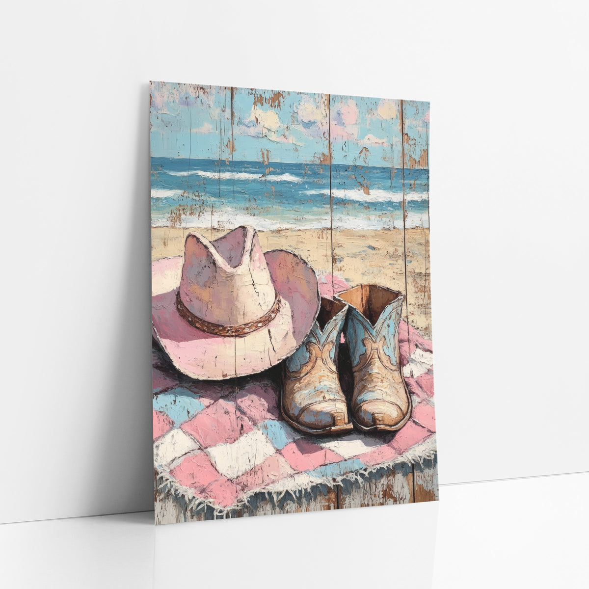 Pink Hat Blue Boots Pastel art print leaning against a white wall – pink cowboy hat and worn blue-and-tan boots