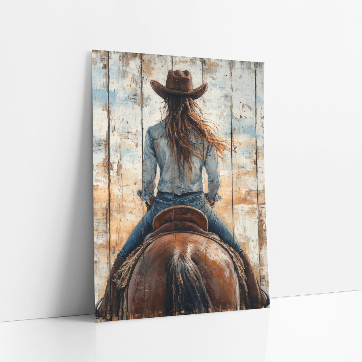 Denim Shirt Rider Closeup Distressed art print leaning against a white wall – cowgirl in brown hat and denim seen from behind