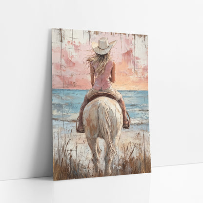 Pink Sunset Cowgirl Dune Western art print leaning against a white wall – cowgirl in white hat on a cream horse, seen