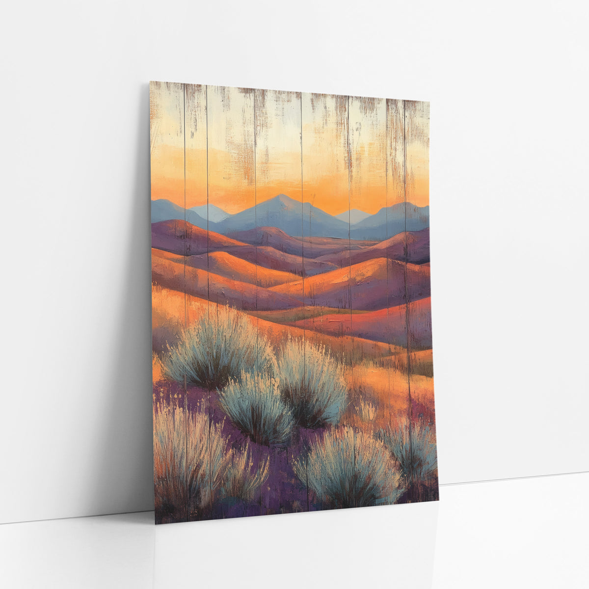 Sunlit Desert Hills Sagebrush Western art print leaning against a white wall – desert hills in orange and purple with blue