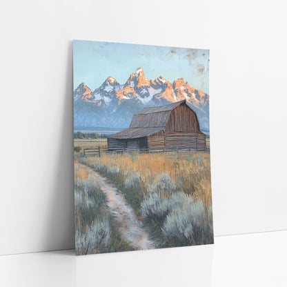 Old Barn Teton Peaks Western art print leaning against a white wall – weathered wooden barn in a golden field with a dirt