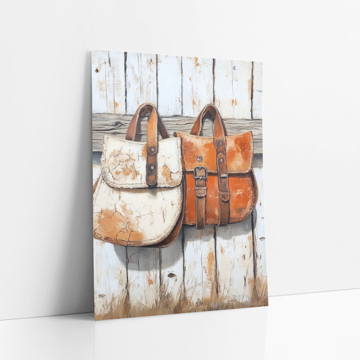 Rustic Leather Saddlebags Western Farmhouse art print leaning against a white wall – two weathered leather saddlebags, one