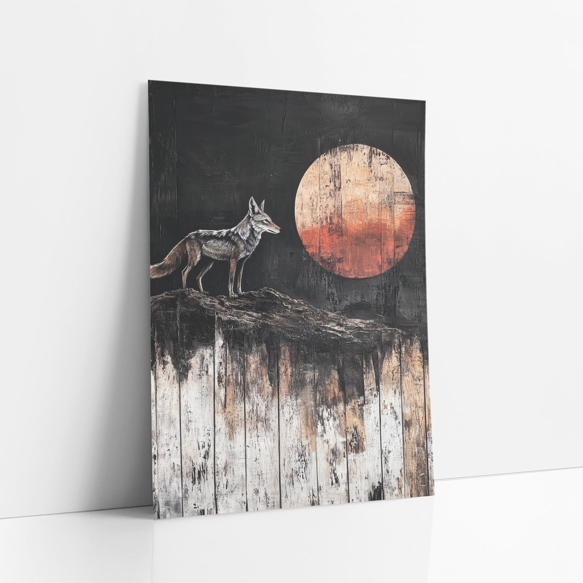 Lone Coyote Rust Moon Western art print leaning against a white wall – gray and tan coyote standing on a ridge facing a large
