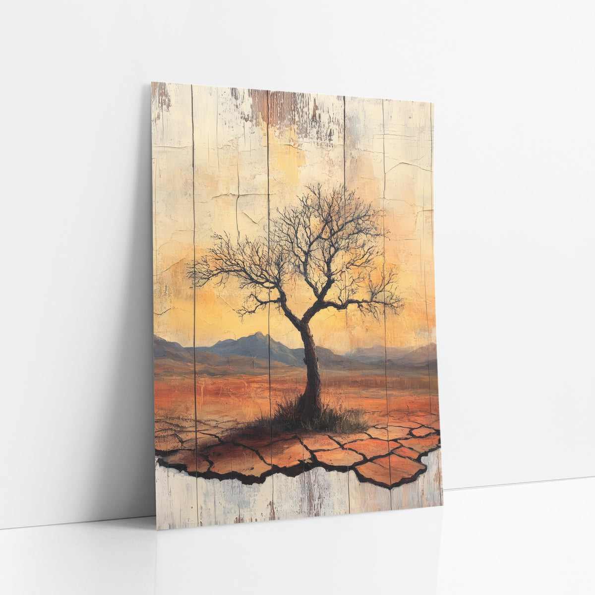 Amber Dusk Bare Tree Rustic art print leaning against a white wall – lone bare tree on cracked orange desert ground