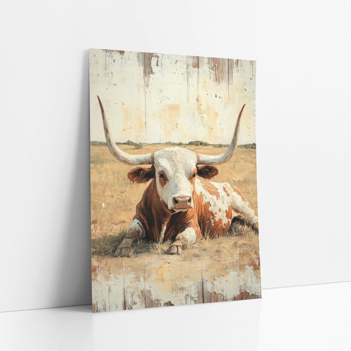 Open Range Longhorn Whitewashed Western art print leaning against a white wall – rust and white longhorn bull lying in dry