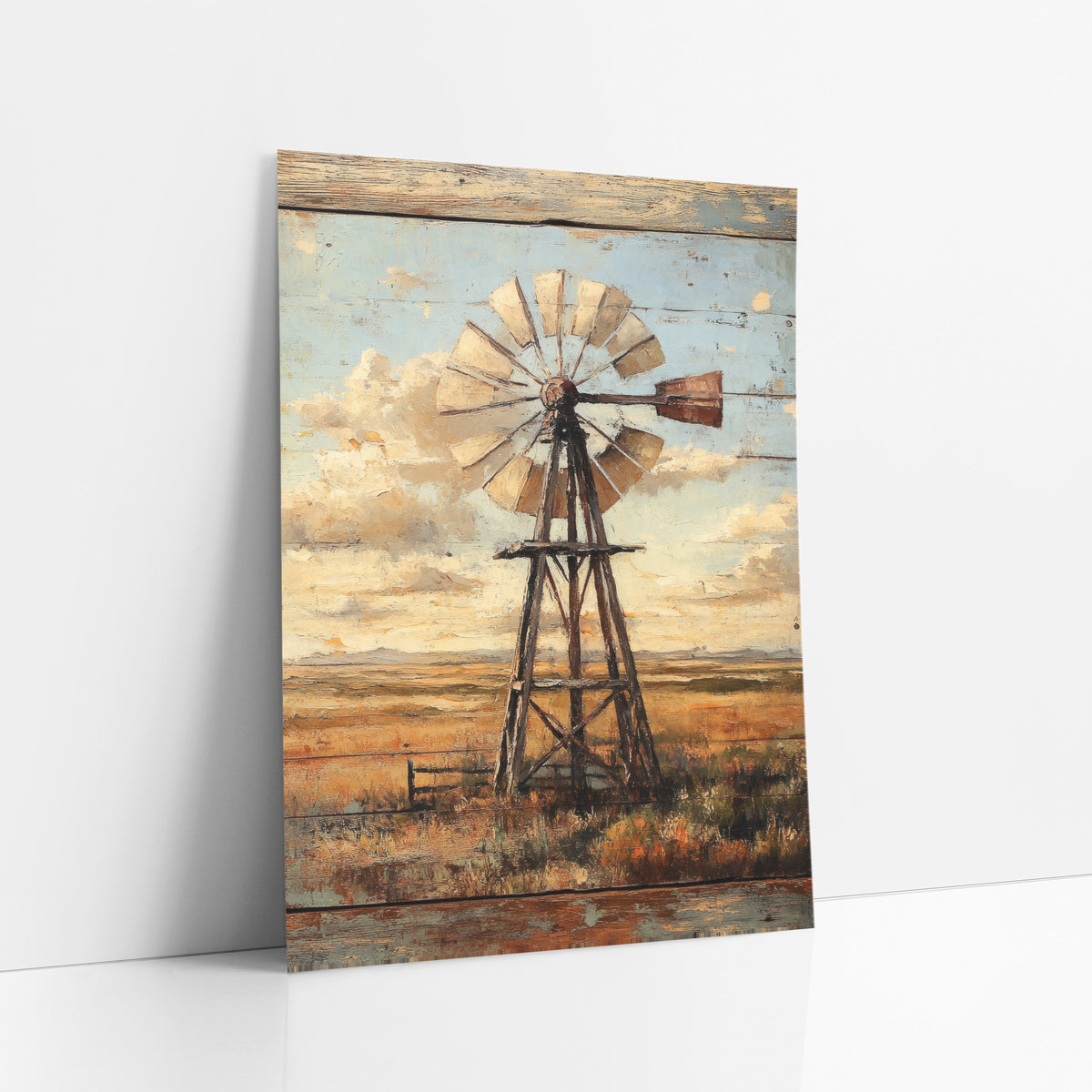 Pale Plank Windmill Vintage art print leaning against a white wall – wooden windmill on open prairie under a cloudy blue sky