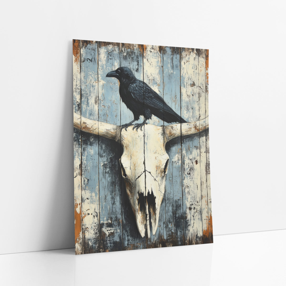 Raven Perched Whitewashed Plank Skull art print leaning against a white wall – black raven standing on a bleached longhorn