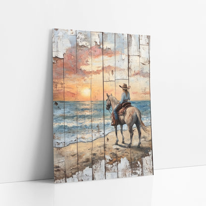 Cowgirl Facing Sunset Surf Rustic art print leaning against a white wall – cowgirl in a brown hat on a gray horse on a sandy