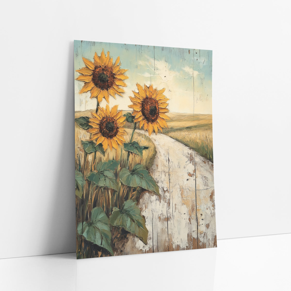 Sunflower Country Road Western Landscape art print leaning against a white wall – three golden sunflowers beside a pale