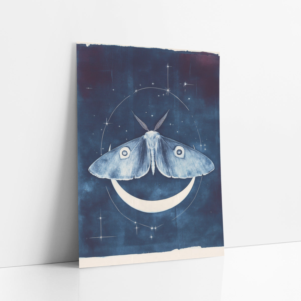 Moth and Crescent Moon Celestial art print leaning against a white wall – pale blue moth with eye spots above a white
