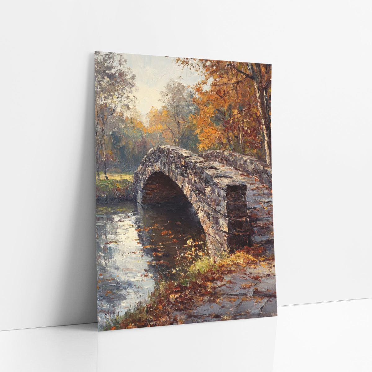 Cobbled Bridge Path Classic art print leaning against a white wall – arched stone bridge over still water, framed by amber