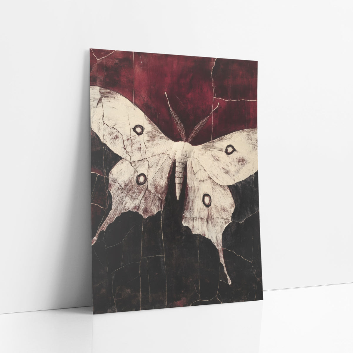 Cream Luna Moth Dark Academia art print leaning against a white wall – cream luna moth with four dark eyespots and long tails
