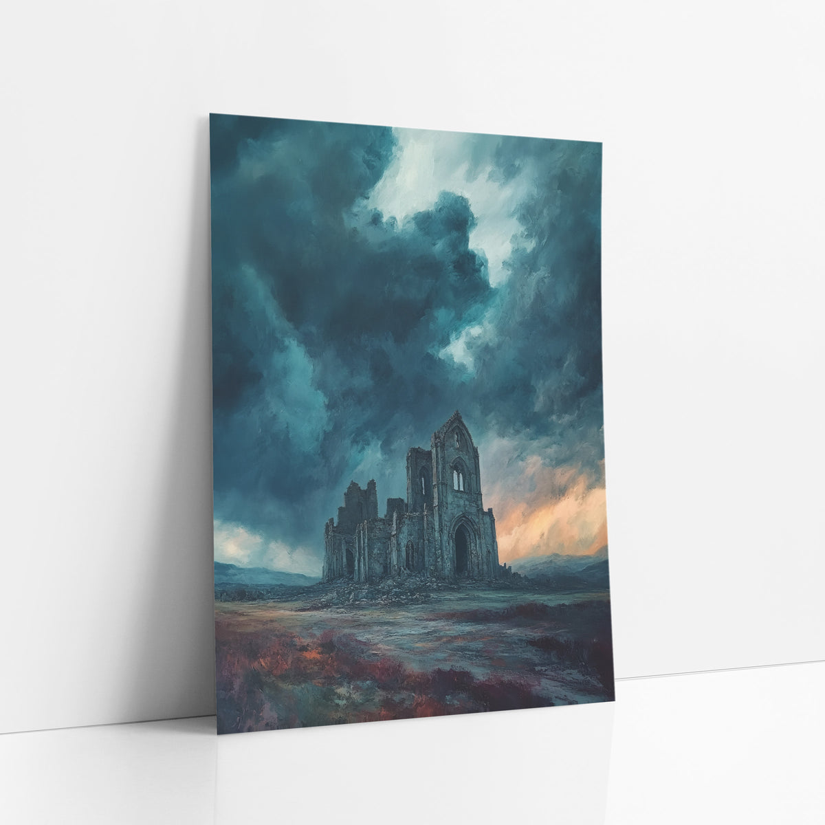 Teal Storm Abbey Moody art print leaning against a white wall – ruined gothic abbey on a moor beneath dark teal storm clouds