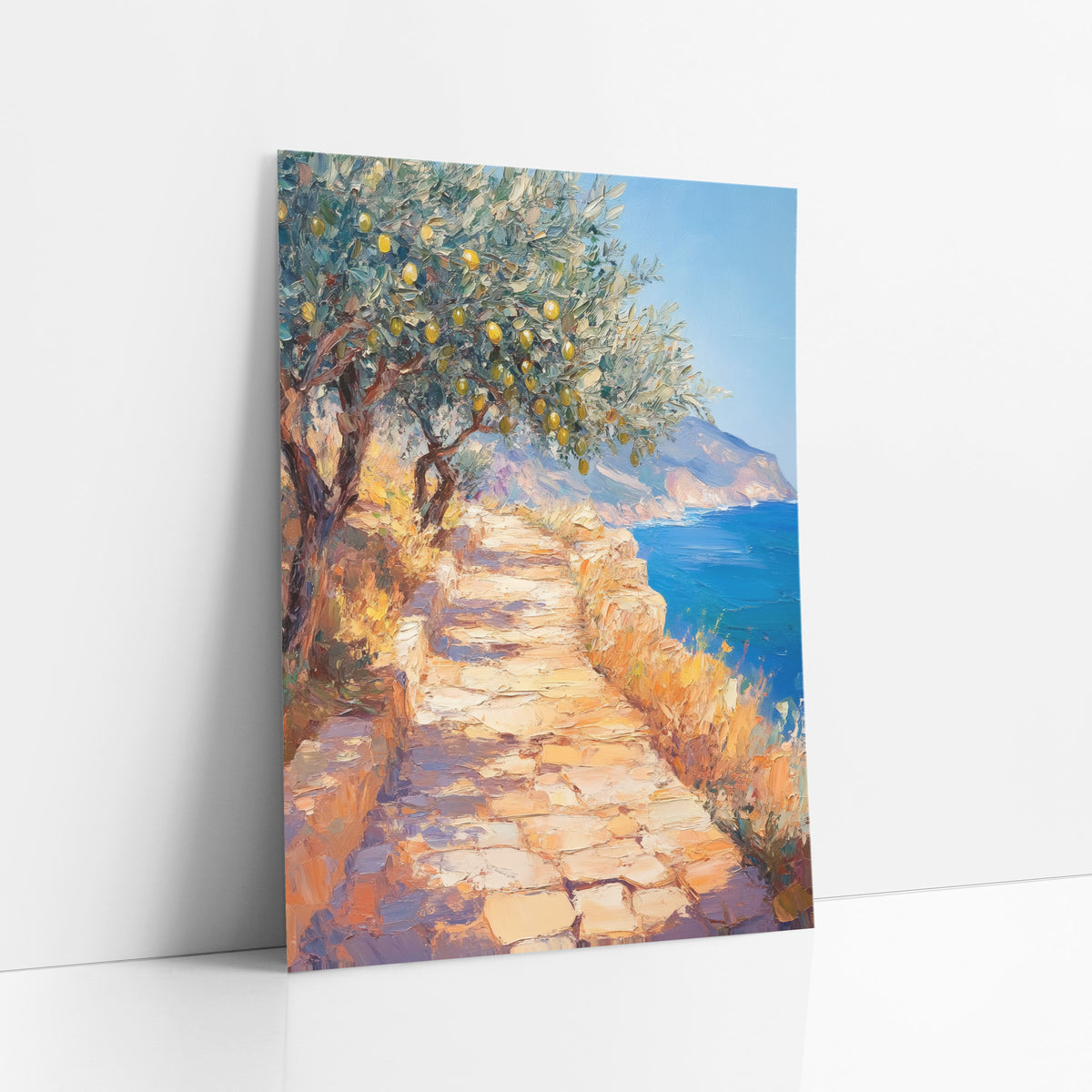 Sunlit Lemon Tree Coastal Path art print leaning against a white wall – impressionist scene of a sunlit stone path beneath