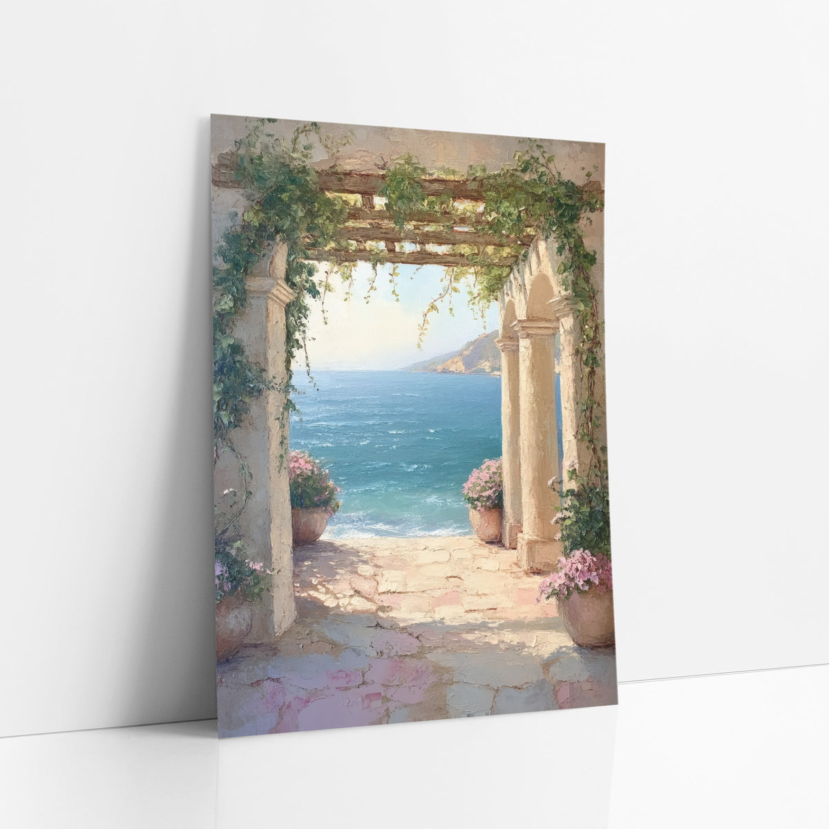 Vine Archway Sea View Coastal art print leaning against a white wall – stone archway draped in green vines frames a turquoise